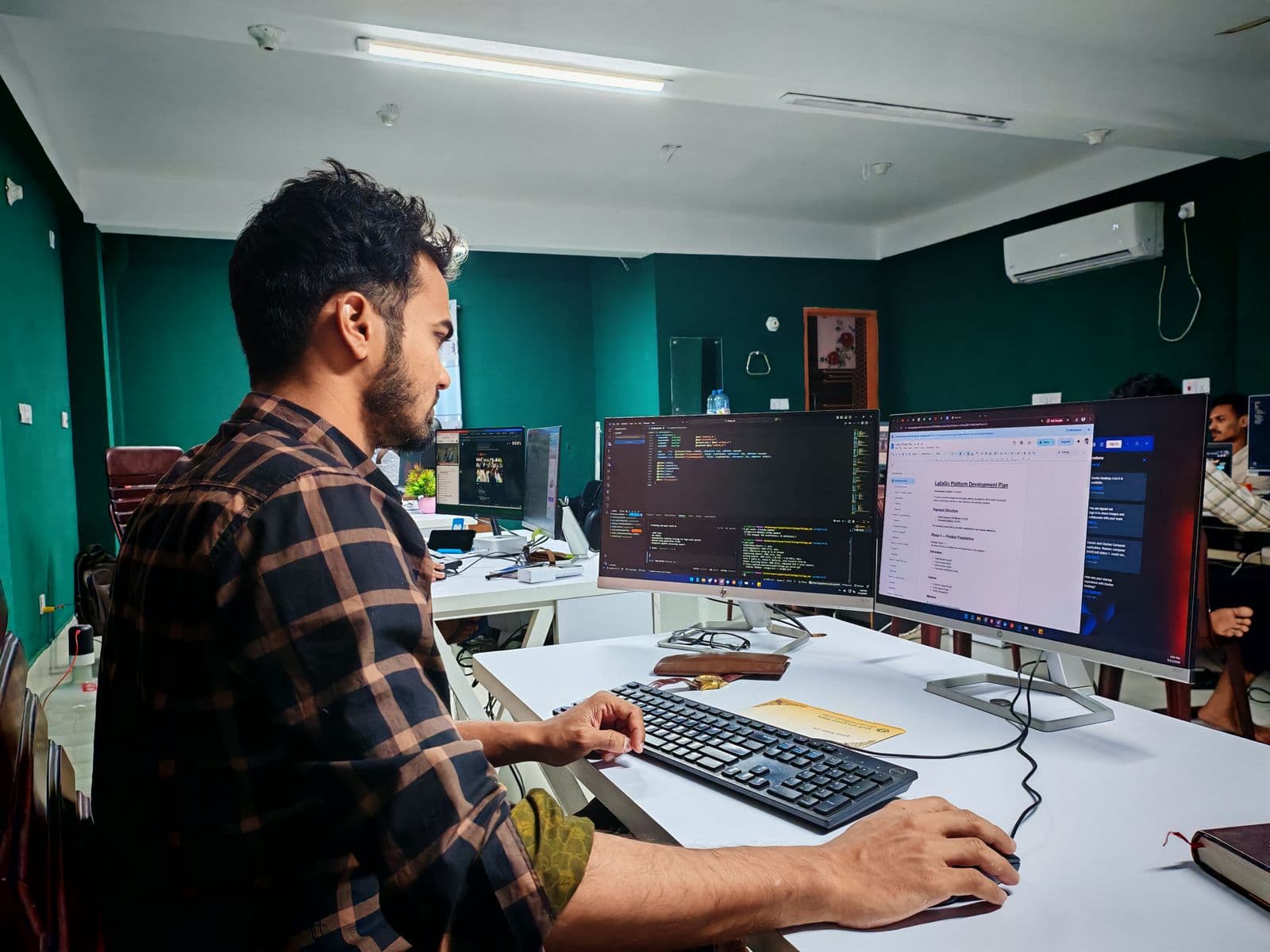 Software developer working on code in a modern office